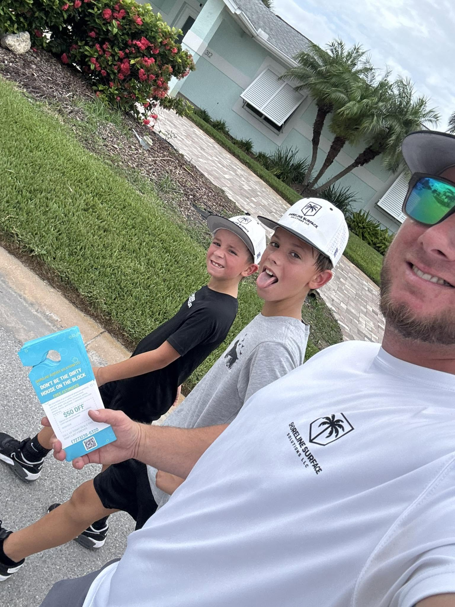 Nik and his sons canvassing a neighborhood in Shoreline branded hats